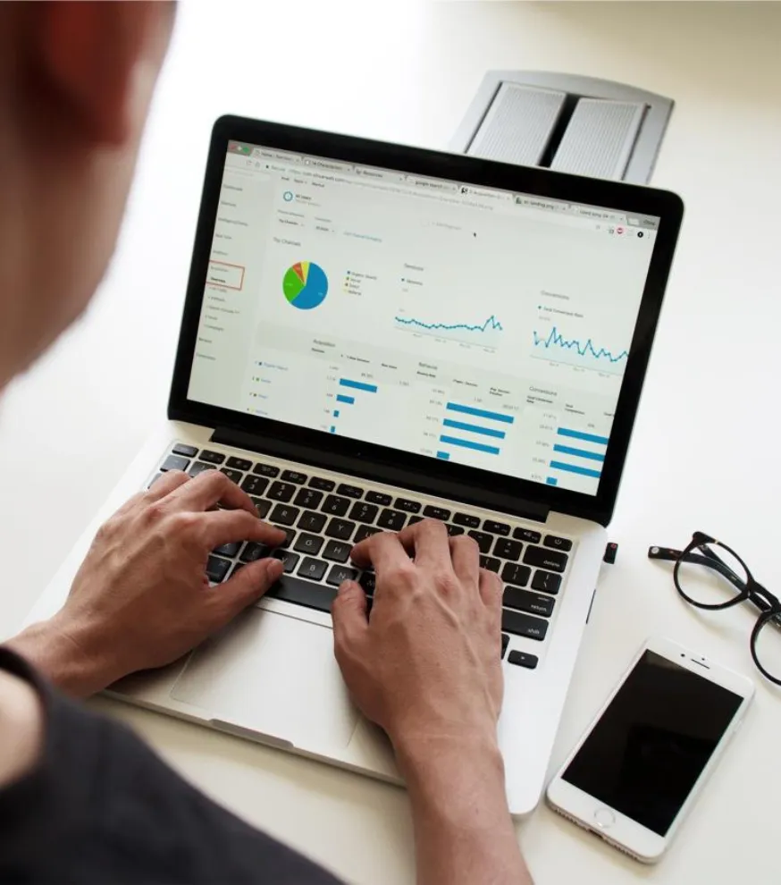 Data scientist analyzing charts and graphs on screen
